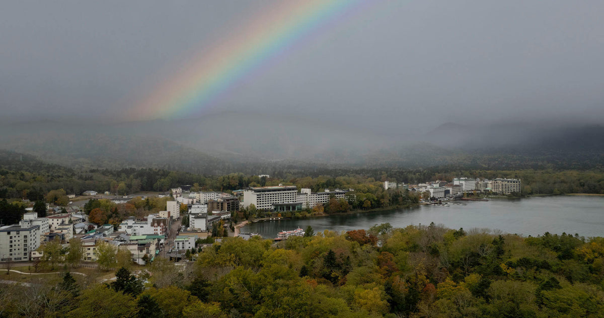 Rainbow over Lake Akan and Akanko Onsen town, the Marimo moss ball capital of Hokkaido, Japan.