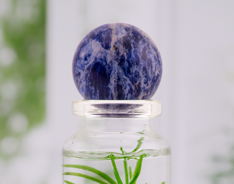 Sodalite crystal ball bottle topper on a glass terrarium bottle