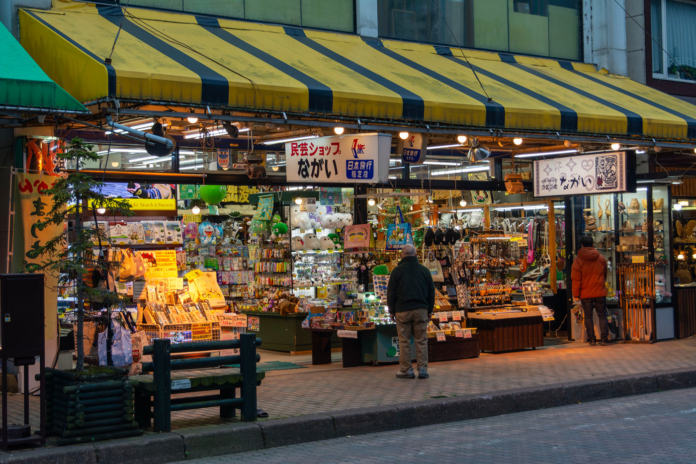 Souvenir shop near the shores of Lake Akan brightly lit and filled with marimo moss ball pets, plushies, and other regional gifts, capturing the local charm and marimo-themed culture of the area.
