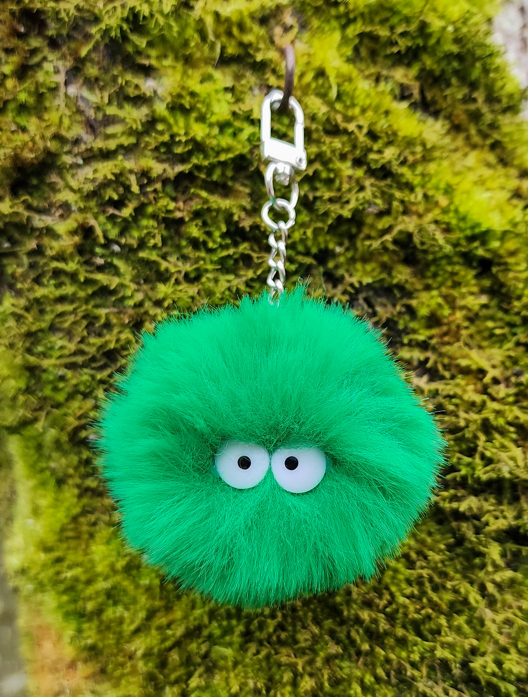 Fluffy Faux Rabbit Fur Moss Ball Pet Keychain made of faux rabbit fur with googly eyes and a silver-tone 360-degree lobster claw clasp.
